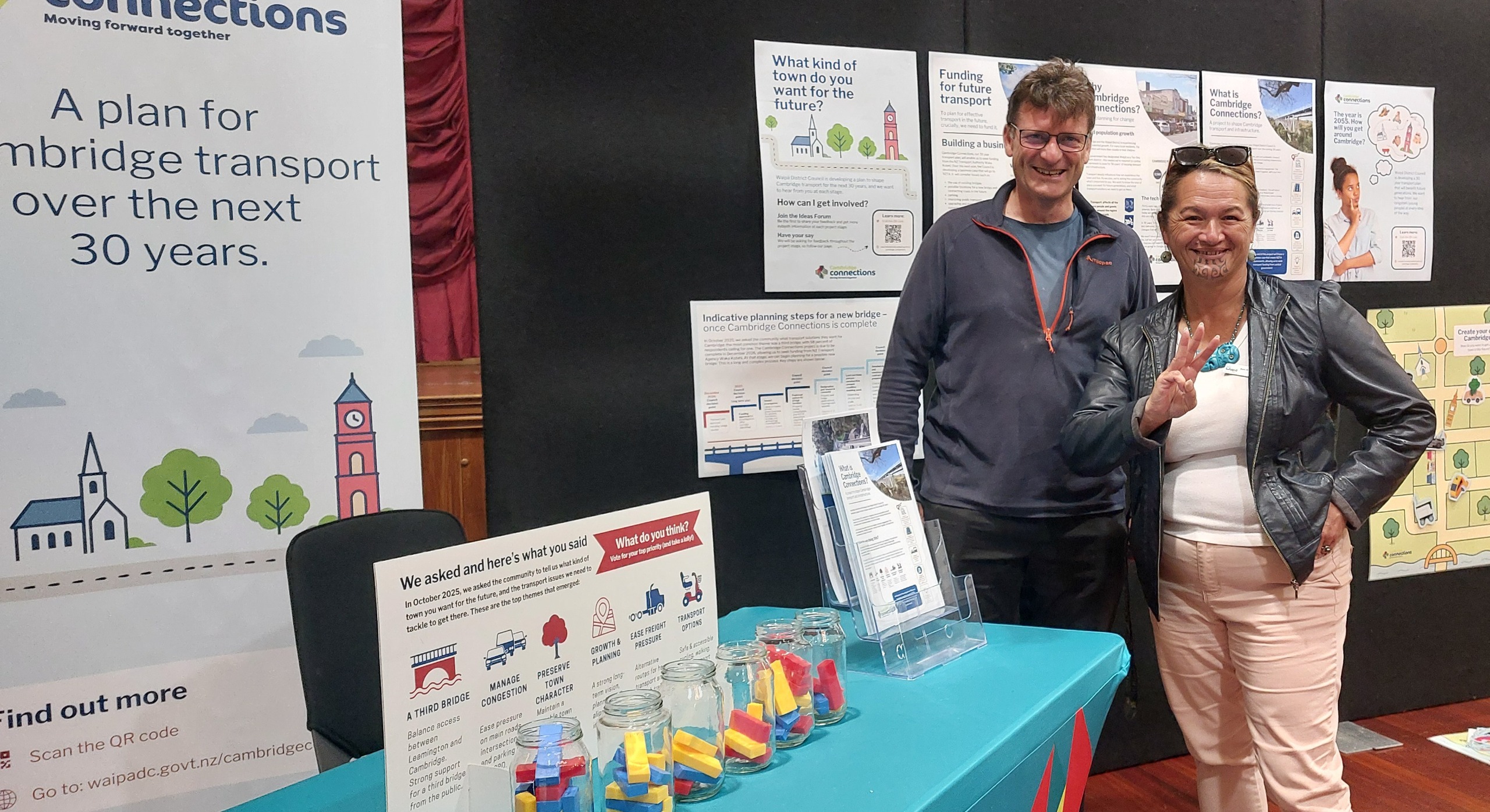 Two counsellors for Waipa District stand at a display for Cambridge Connections