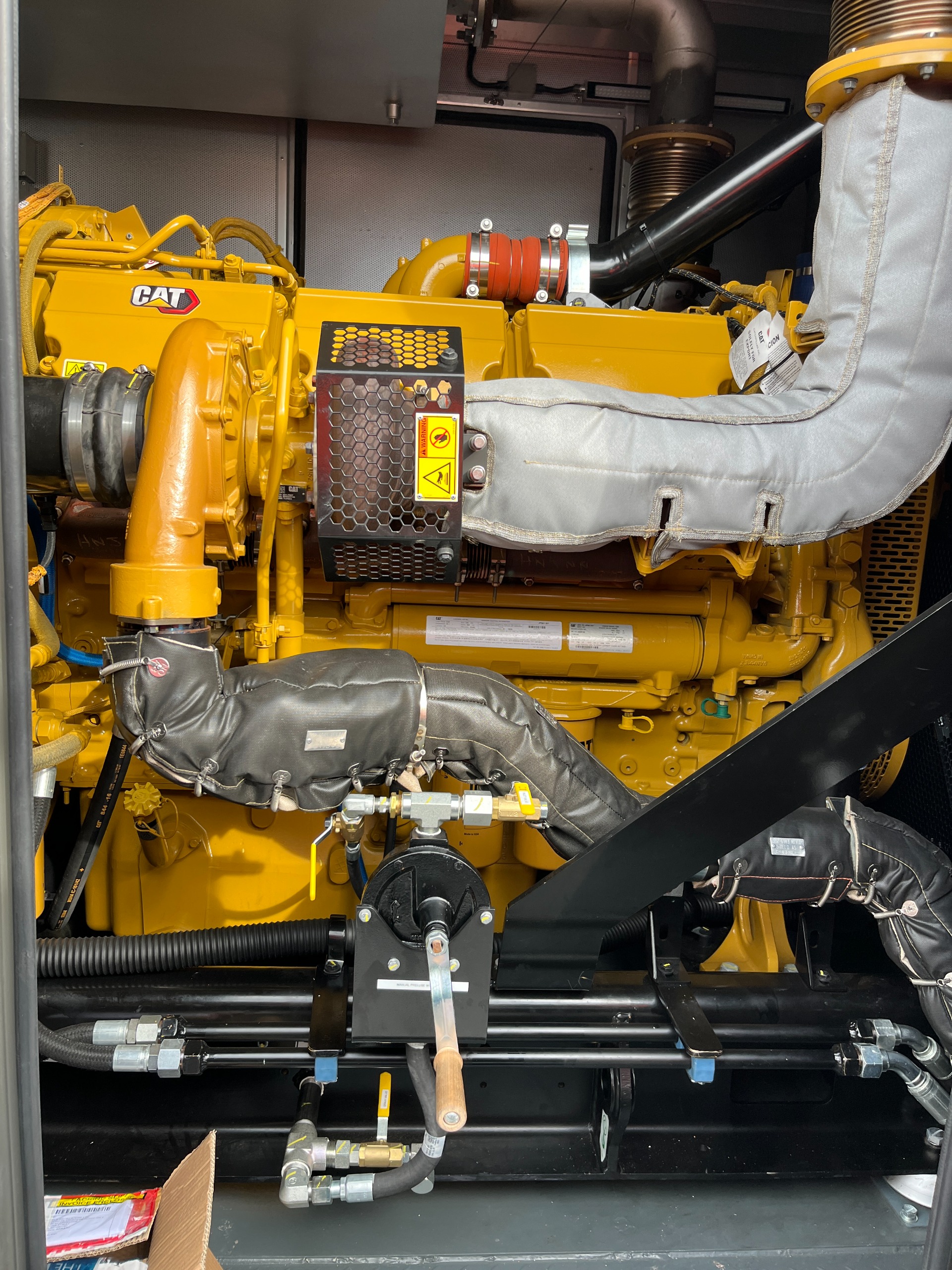 New yell CAT generator with leather covers over the pipes 