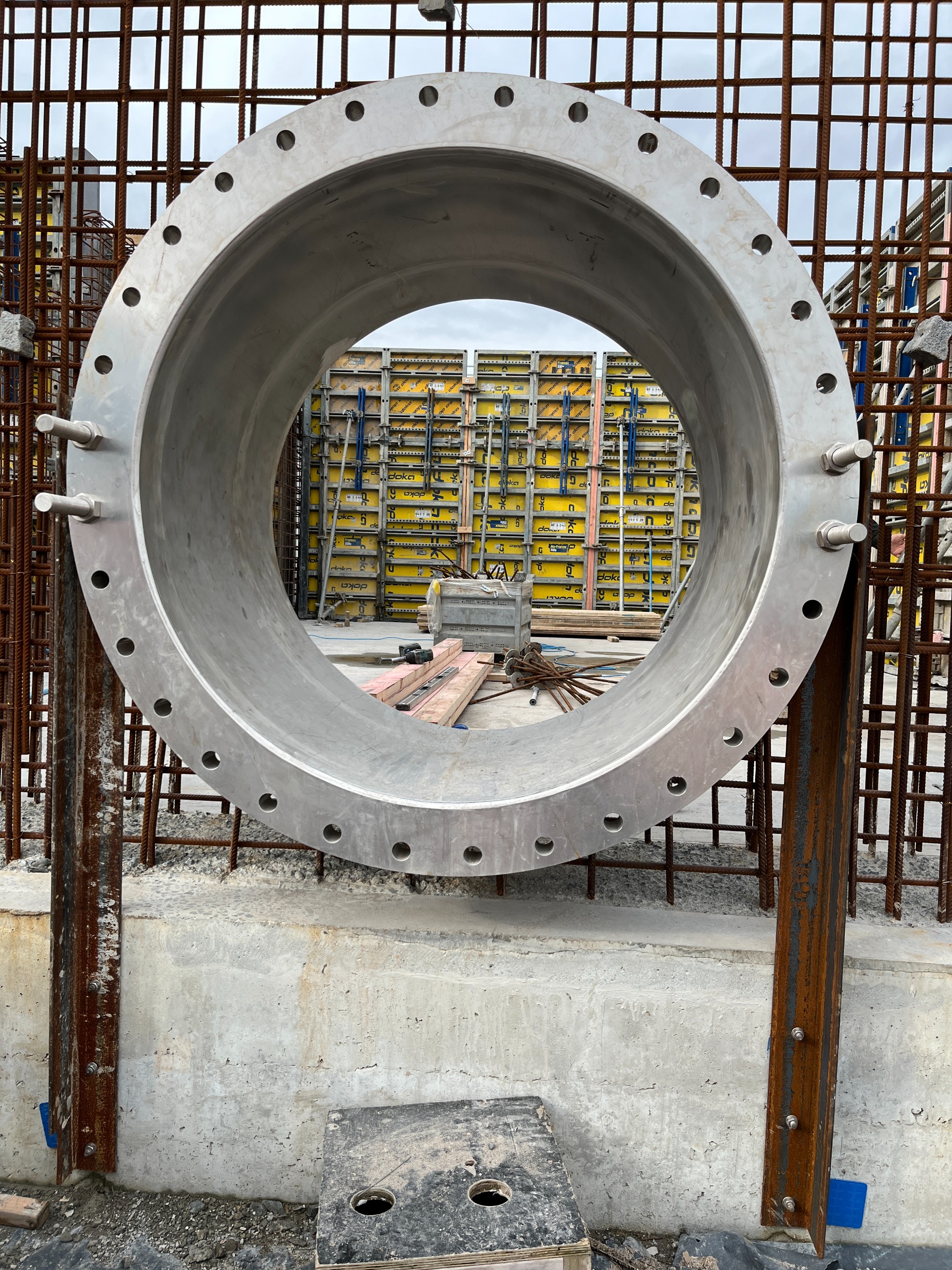 Stainless steel porthole attached to steel foundations